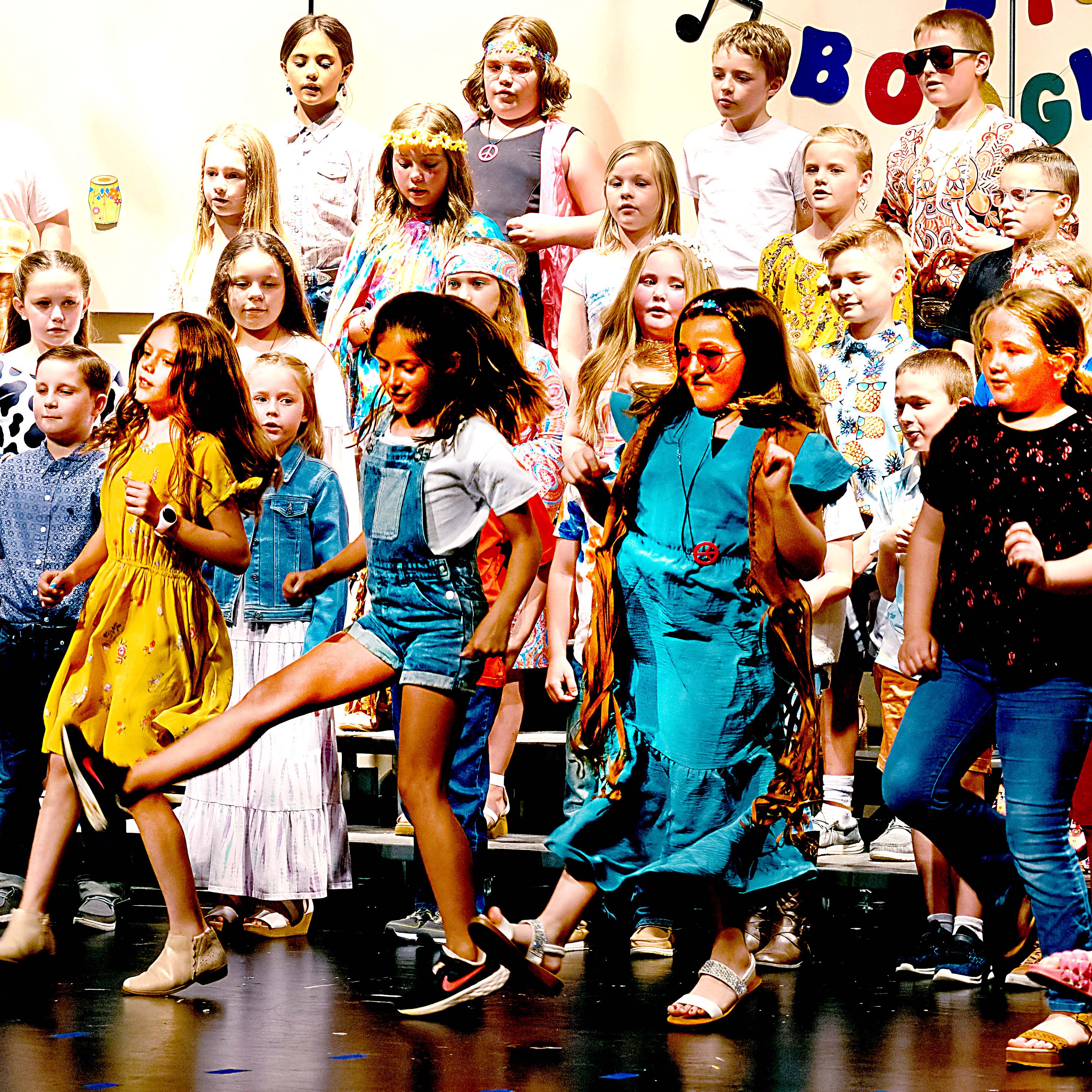 Students twirl and sing as pre-kindergarten through fifth grade classes perform "Do-Re-Mi," by Rodgers and Hammerstein, during an all-school music program last week at Centre schools.
